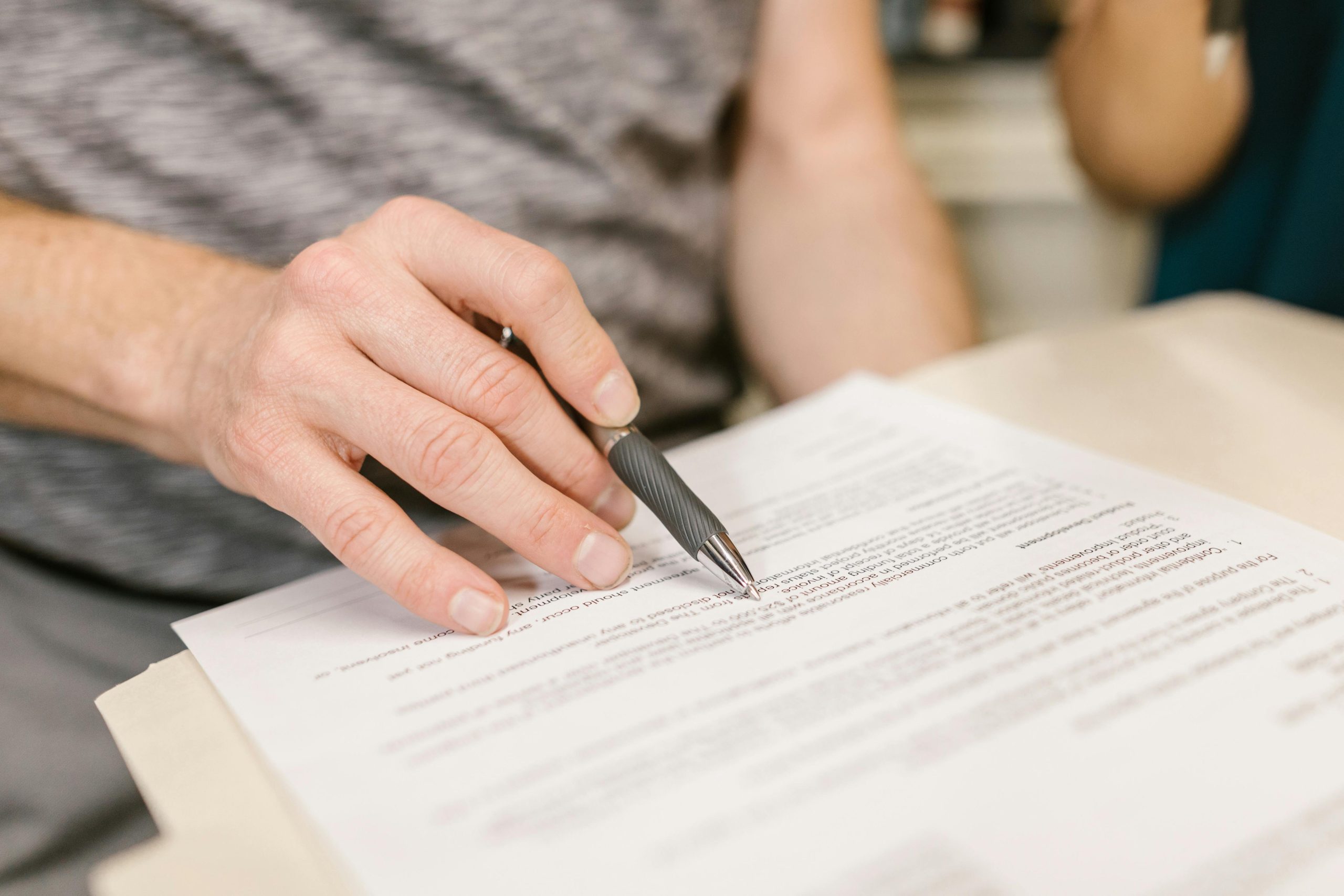 Person writing on white paper